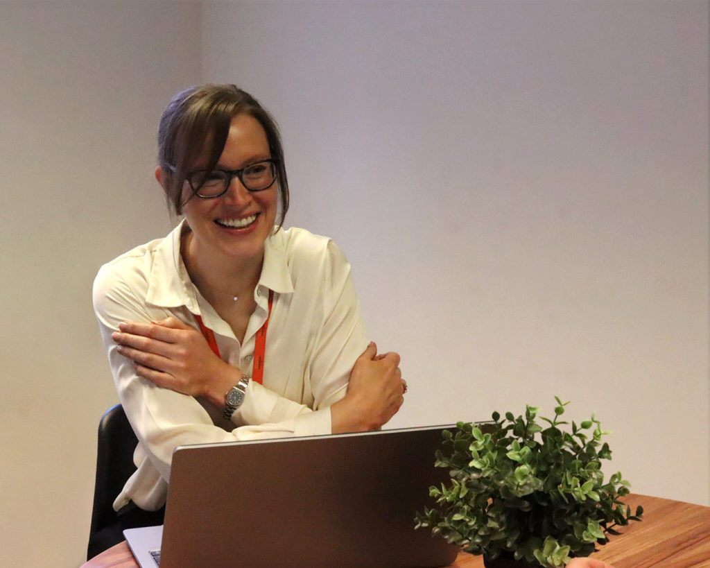 Reeves advisor smiling whilst on laptop.