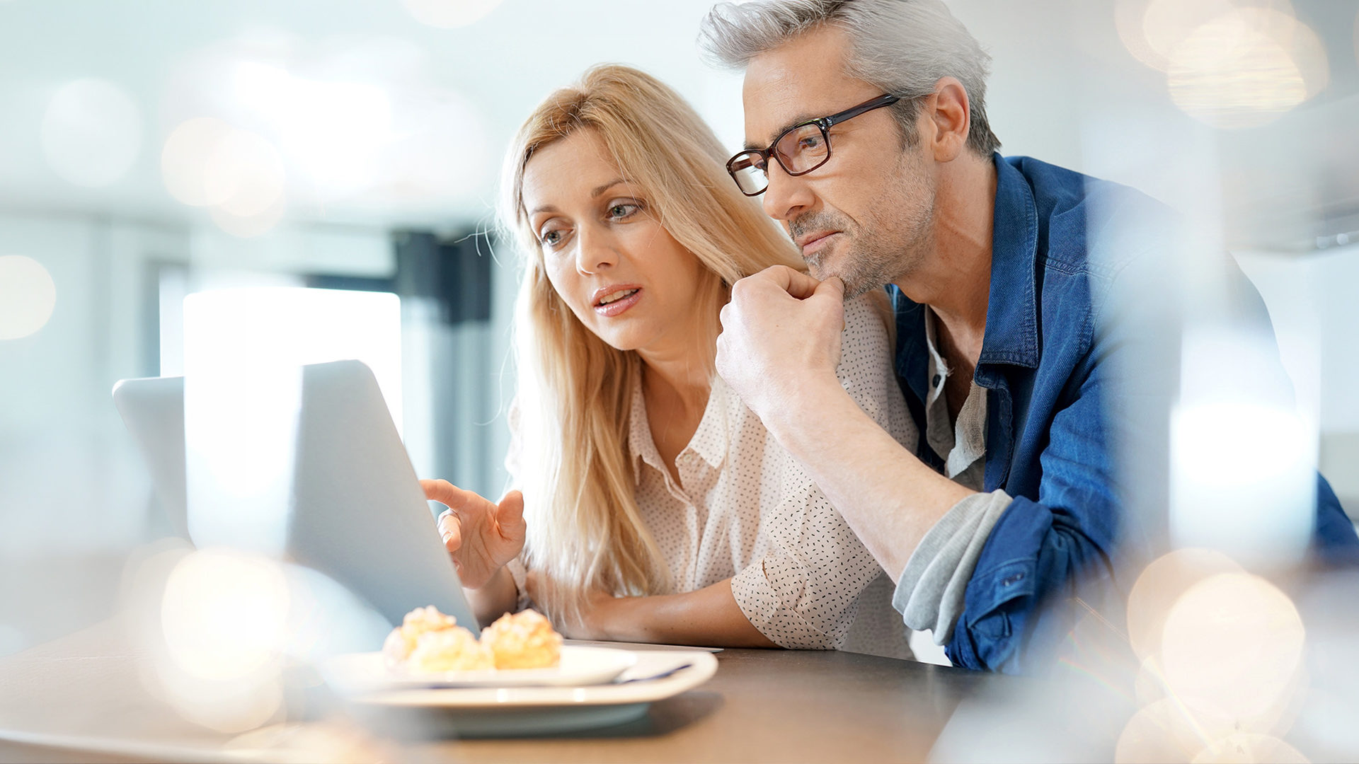 Couple watching a webinar on a laptop.