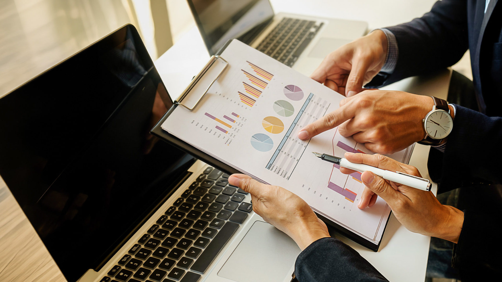 Two people examining charts.