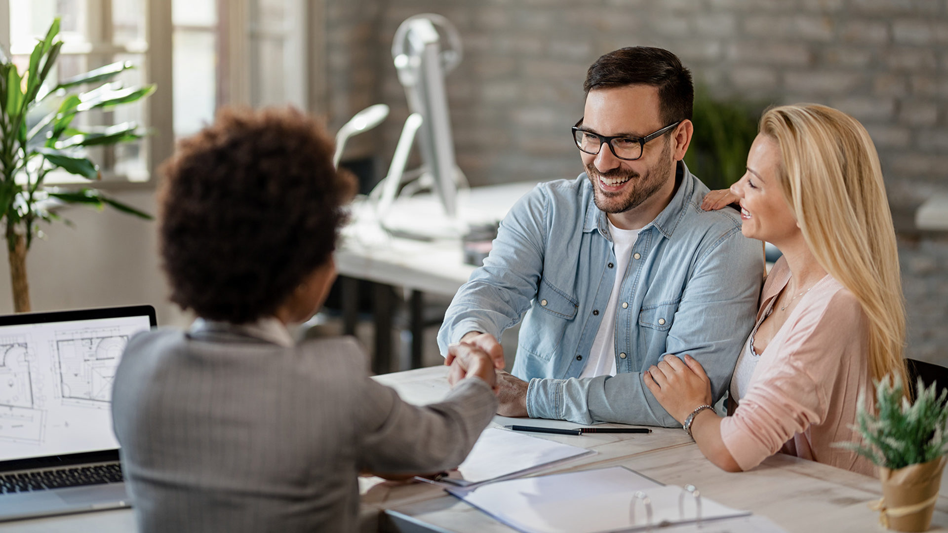 Couple sitting down with their financial advisor for a meeting