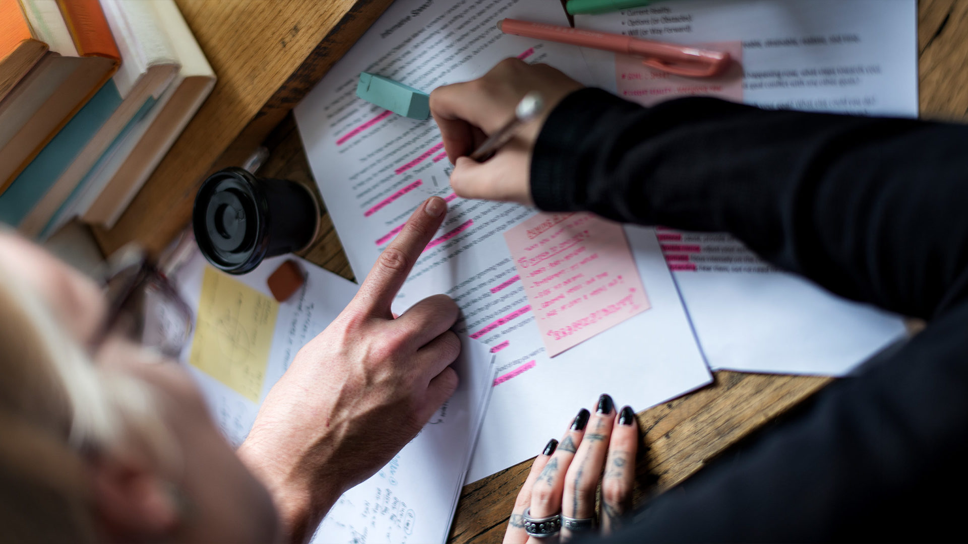 Hands highlighting documents.