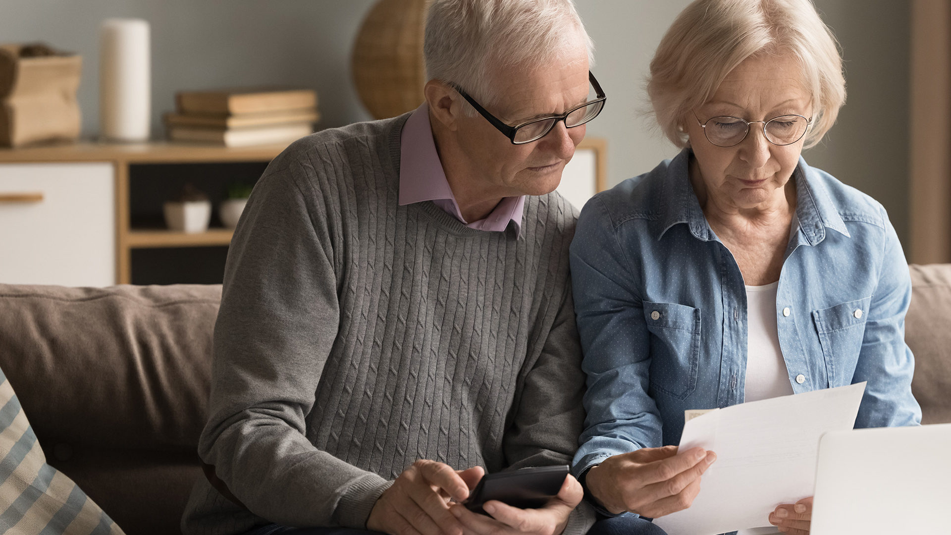 Older couple looking through paperwork.