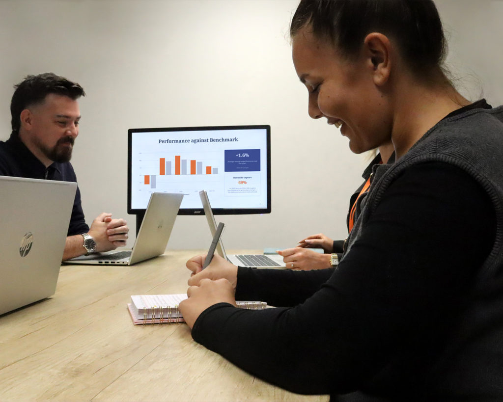 Reeves team members at a meeting taking notes and presenting.