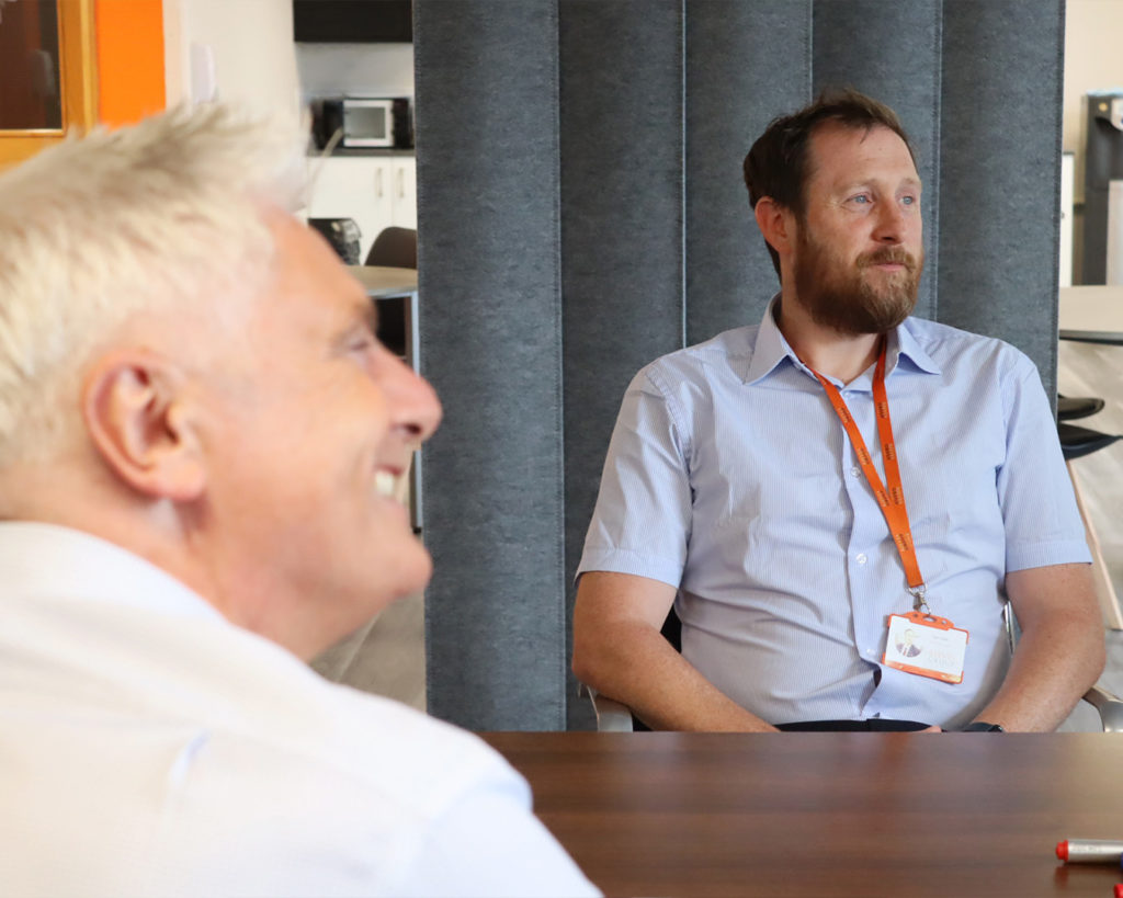 Two Reeves staff members in a team meeting.