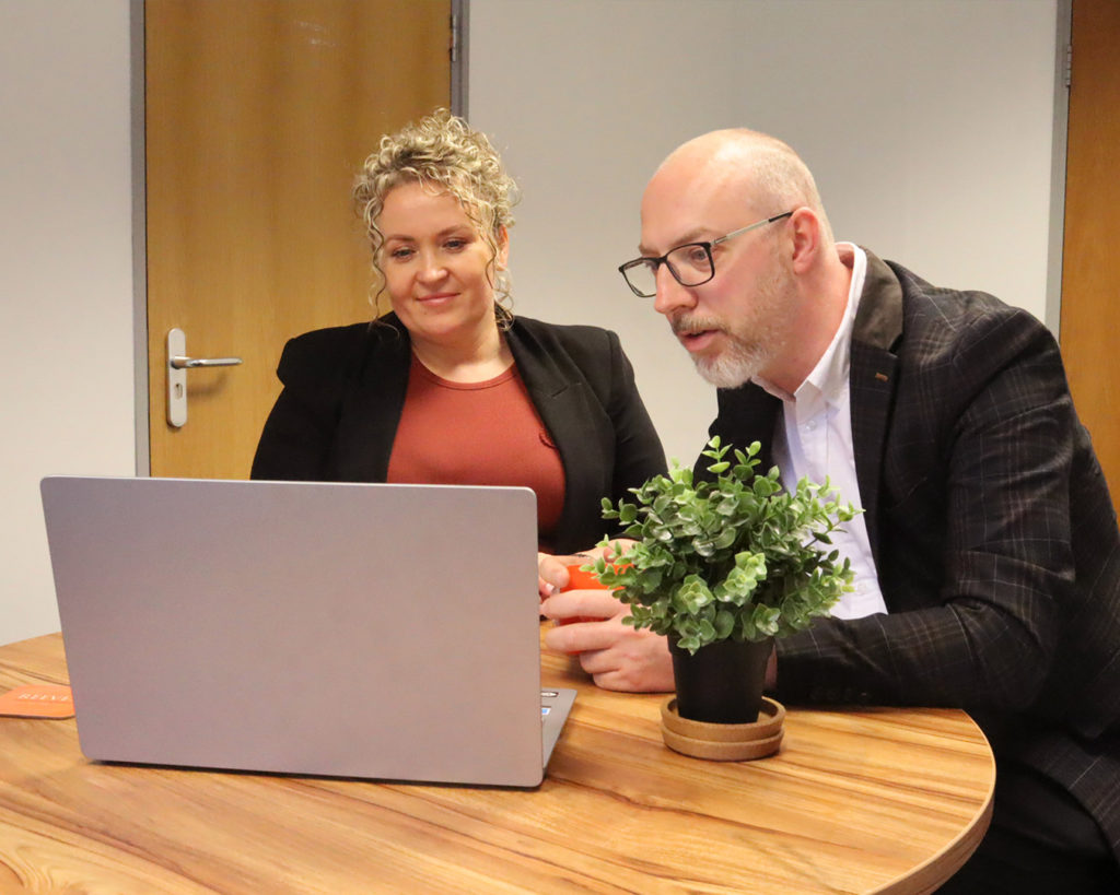 Two Reeves clients looking on laptop.