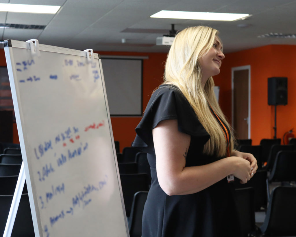 Reeves staff member standing in front of a whiteboard presenting.