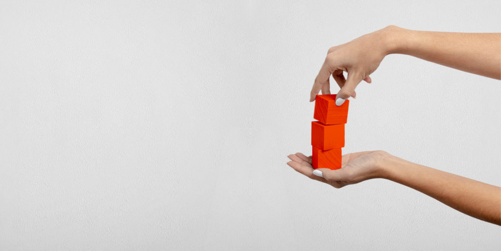 Hands holding building blocks