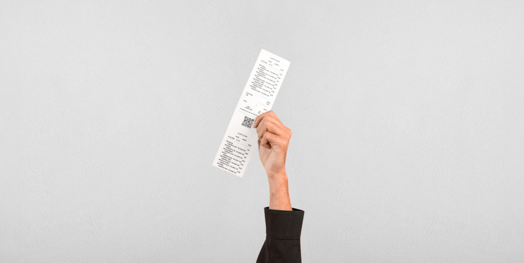 Hand holding a receipt.
