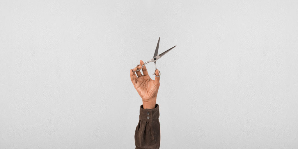 Hand holding a pair of scissors.