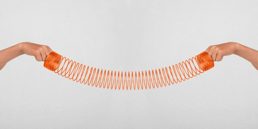 Hands holding a stretched slinky