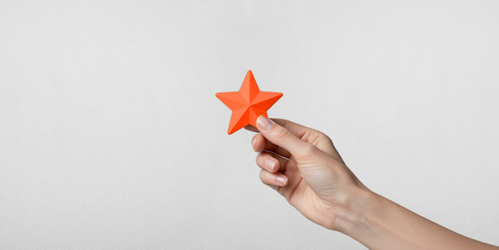 Hand holding a star.